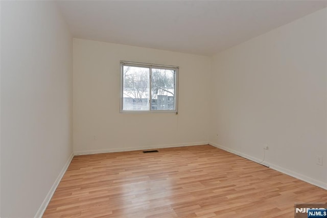 unfurnished room featuring light hardwood / wood-style floors