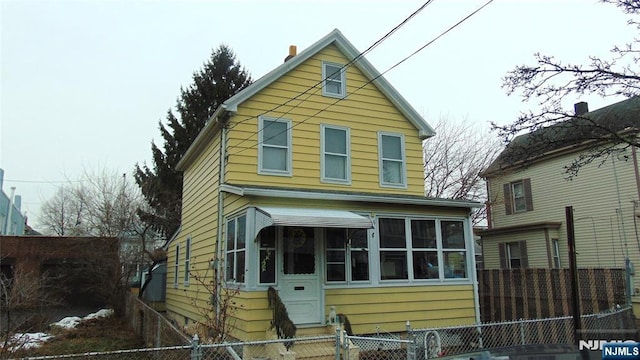 view of front of property with a sunroom