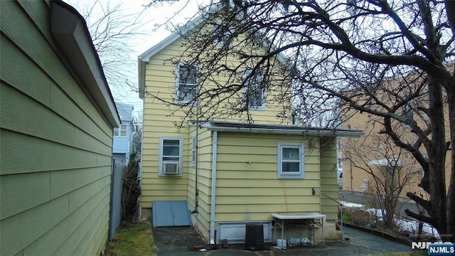 view of side of home featuring cooling unit