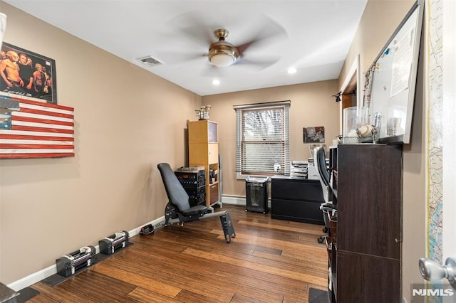 office with a baseboard radiator, hardwood / wood-style floors, and ceiling fan