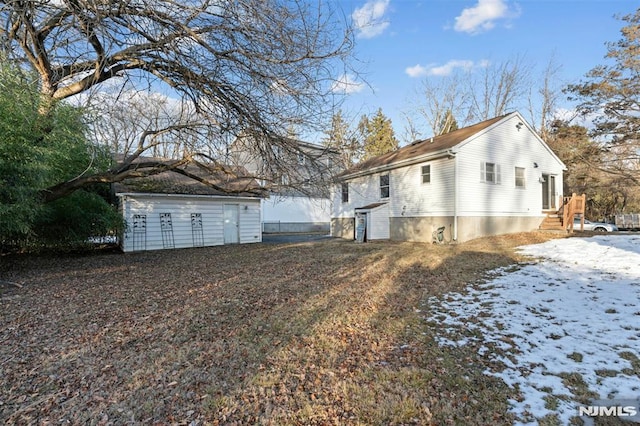 view of snow covered exterior with an outdoor structure