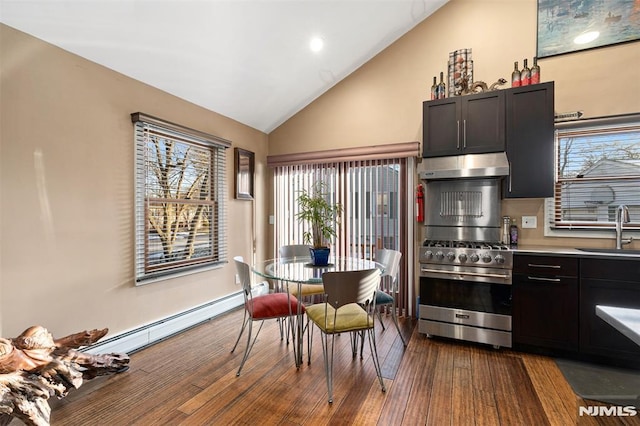 kitchen with sink, stainless steel stove, a baseboard heating unit, dark hardwood / wood-style flooring, and vaulted ceiling