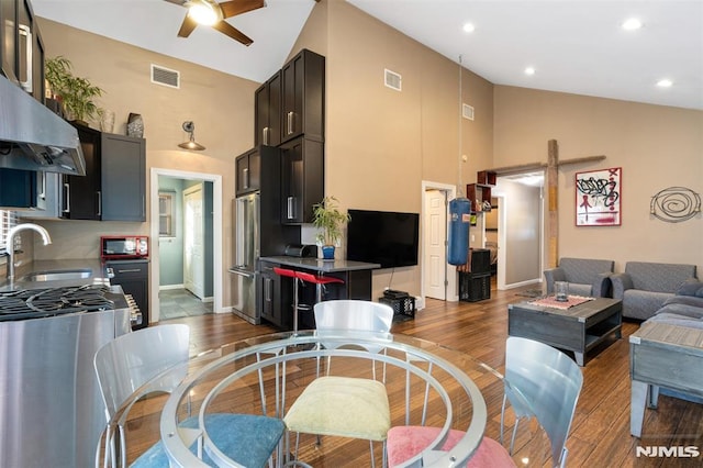 living room featuring dark hardwood / wood-style flooring, sink, high vaulted ceiling, and ceiling fan