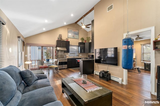 living room with high vaulted ceiling, baseboard heating, dark hardwood / wood-style floors, ceiling fan, and beam ceiling