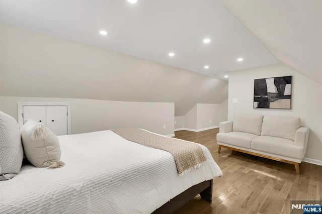 bedroom featuring wood-type flooring and vaulted ceiling