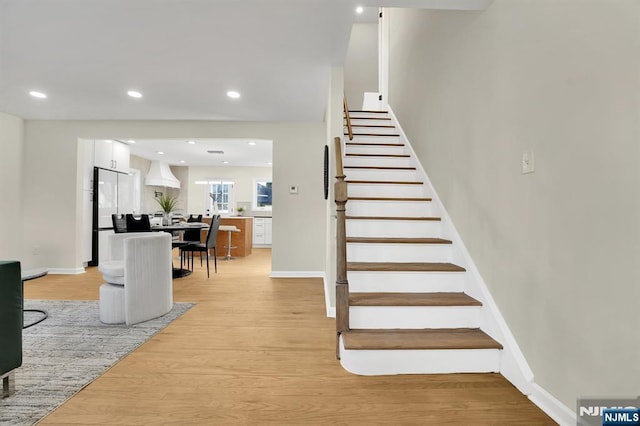 stairs featuring hardwood / wood-style flooring