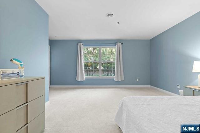 bedroom featuring light colored carpet