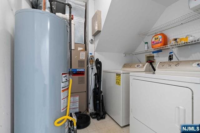 laundry room with washer and clothes dryer and water heater