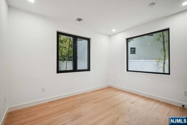 spare room featuring light hardwood / wood-style flooring