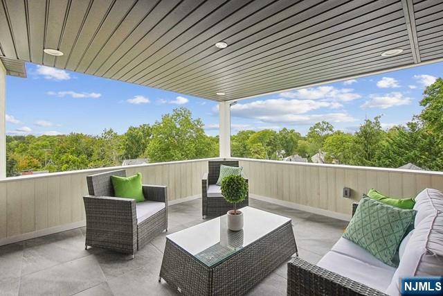 balcony with an outdoor hangout area and a patio