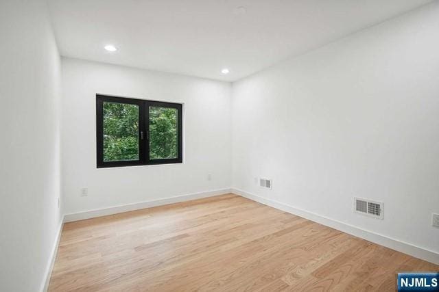 empty room with light hardwood / wood-style floors