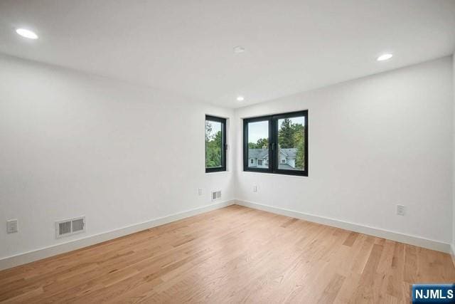 spare room with light wood-type flooring