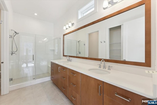 bathroom featuring vanity, tile patterned flooring, and walk in shower