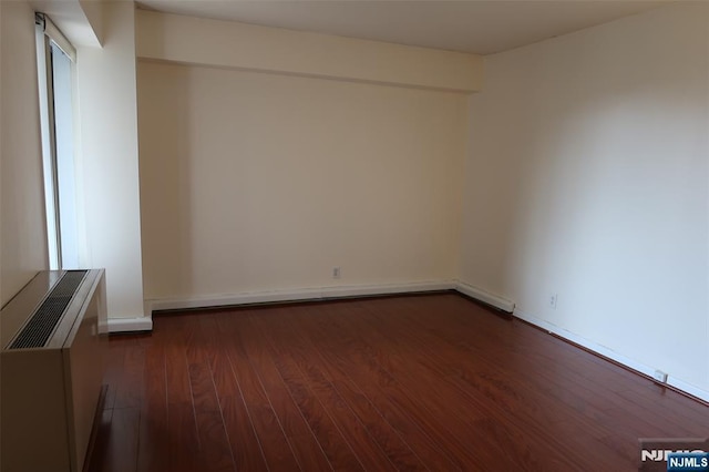 empty room featuring dark wood-type flooring