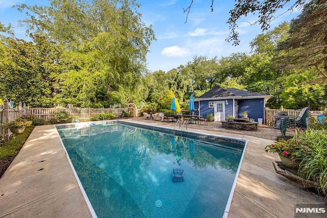 view of swimming pool featuring an outdoor structure and a patio