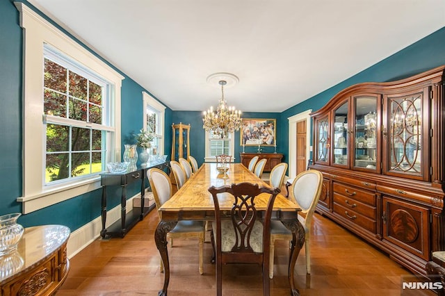 dining area featuring hardwood / wood-style floors and a chandelier