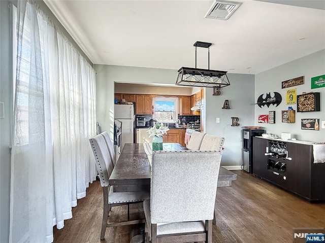 dining space featuring dark hardwood / wood-style floors