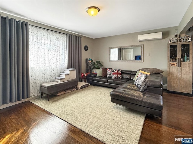 living room featuring dark wood-type flooring, a baseboard radiator, and a wall unit AC