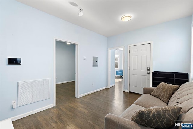 living room with electric panel and dark hardwood / wood-style floors