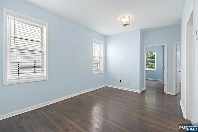 unfurnished room with dark hardwood / wood-style floors