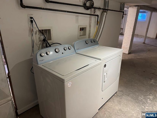 clothes washing area with separate washer and dryer