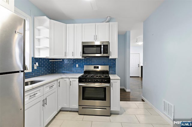 kitchen featuring white cabinetry, appliances with stainless steel finishes, and backsplash