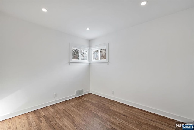 spare room featuring wood-type flooring