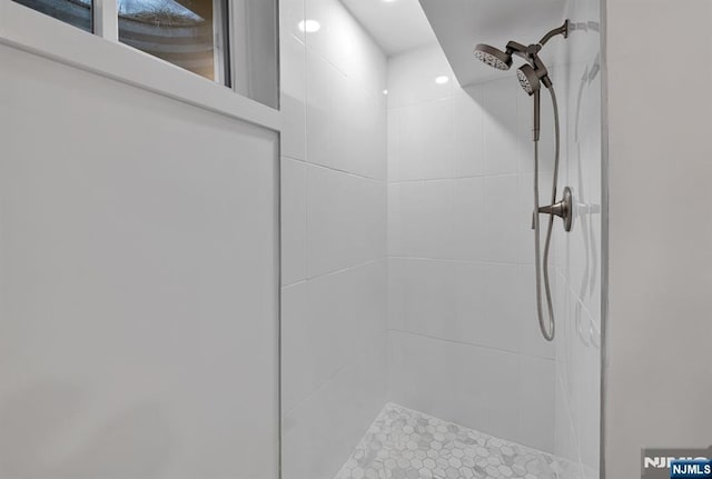 interior details with a tile shower