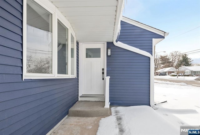 view of snow covered property entrance