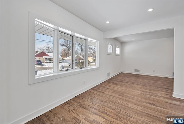 spare room with hardwood / wood-style floors