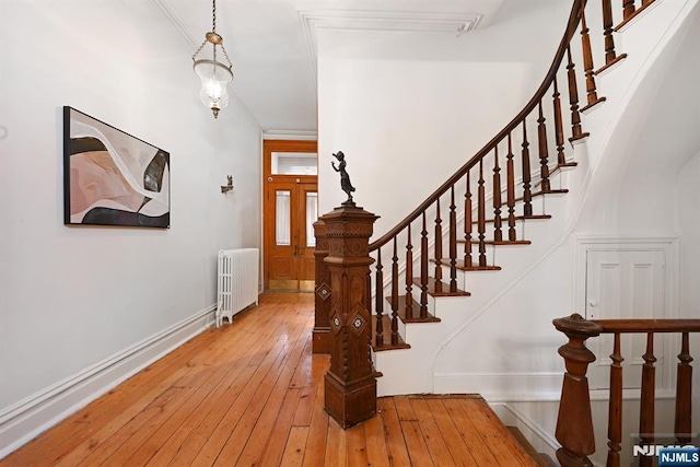 interior space with hardwood / wood-style flooring and radiator heating unit