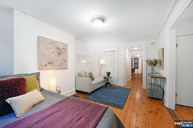 bedroom featuring ornamental molding, hardwood / wood-style floors, and a closet