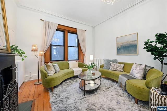 living room with ornamental molding and hardwood / wood-style floors