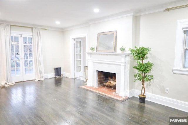 unfurnished living room with radiator, ornamental molding, and dark hardwood / wood-style floors