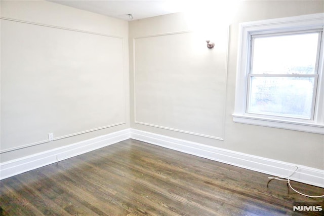 spare room featuring dark hardwood / wood-style floors