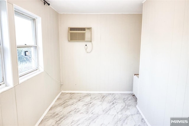 unfurnished room featuring radiator and a wall unit AC