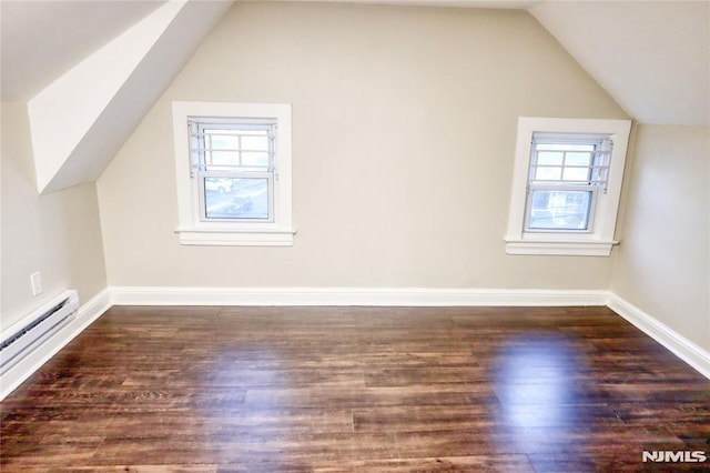 additional living space with dark wood-type flooring, lofted ceiling, and baseboard heating