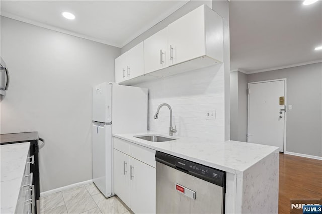 kitchen featuring white cabinetry, stainless steel dishwasher, sink, and white fridge