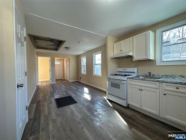 kitchen with white cabinetry, white gas range, sink, and light stone counters