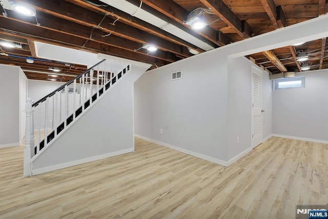 basement featuring light hardwood / wood-style floors