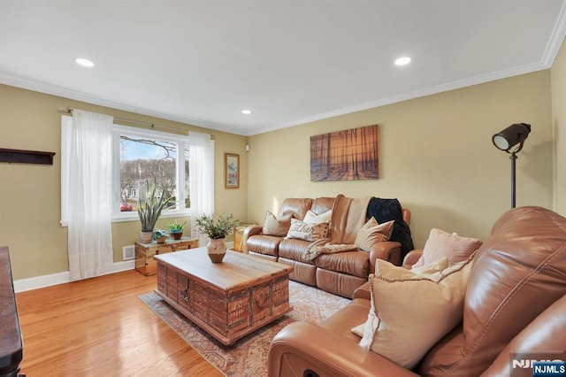 living room featuring light hardwood / wood-style flooring and ornamental molding