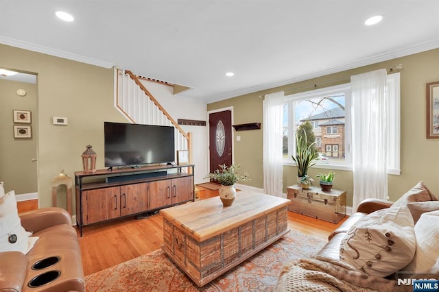 living room featuring ornamental molding and light wood-type flooring