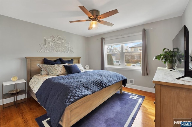 bedroom with ceiling fan and dark hardwood / wood-style floors