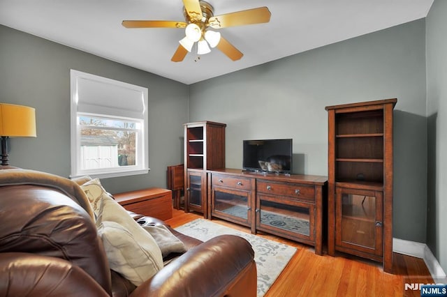 living room with ceiling fan and light hardwood / wood-style floors