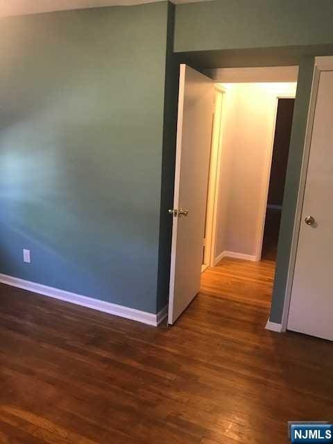 hallway with dark wood-type flooring