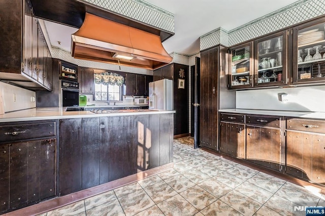 kitchen with light tile patterned flooring, dark brown cabinets, oven, and white fridge with ice dispenser