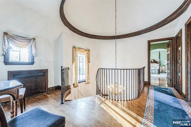 interior space featuring crown molding, hardwood / wood-style floors, and an inviting chandelier