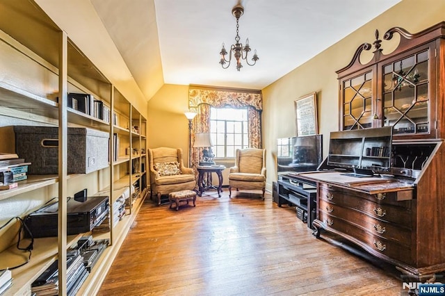 office featuring lofted ceiling, hardwood / wood-style floors, and a chandelier