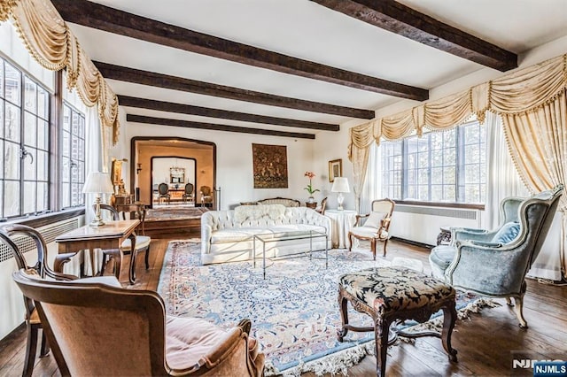 living area featuring hardwood / wood-style flooring and beam ceiling