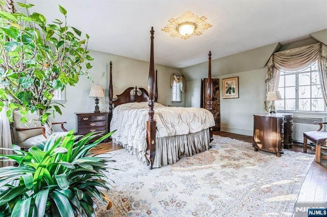 bedroom featuring radiator and wood-type flooring